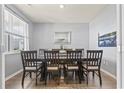 Formal dining room featuring a wooden table set with seating for eight, modern light fixtures, and stylish decor at 7037 Grant St., Little River, SC 29566