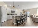 Spacious kitchen featuring stainless steel appliances, a granite island with barstool seating, and an adjacent dining area at 7037 Grant St., Little River, SC 29566
