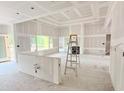 A spacious living room features a ladder, large windows, and a tray ceiling under construction at 804 Edisto Ct., Myrtle Beach, SC 29588