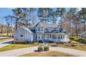 Beautiful home featuring manicured landscaping, stone driveway accents, and mature trees at 901 Bear Lake Dr., Longs, SC 29568