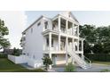 Elegant three-story home featuring a double porch, white railing, and convenient drive-under garage at 914 Perrin Dr., North Myrtle Beach, SC 29582