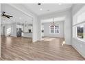 Open-concept living space with hardwood floors and natural light with views into the kitchen at 186 Palmetto Harbour Dr., North Myrtle Beach, SC 29582