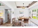 Bright dining room with stylish rug, modern light fixture, and comfortable seating at 232 Marbella Dr., Murrells Inlet, SC 29576