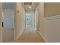 Bright hallway with neutral paint, carpet flooring, and multiple doorways, creating easy flow to the home at 3329 Sw Wood Stork Dr., Ocean Isle Beach, NC 28469