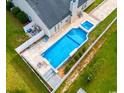 Aerial view of a backyard oasis featuring a pool, spa, patio, and lush landscaping, perfect for outdoor enjoyment at 601 Seth Ln., Longs, SC 29568