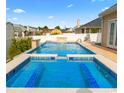 Luxurious backyard pool with a built-in spa, waterfall feature, and ample space for relaxation at 601 Seth Ln., Longs, SC 29568