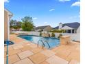 Beautiful pool with stone accents and a waterfall feature, perfect for relaxation and enjoyment during warm days at 601 Seth Ln., Longs, SC 29568