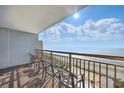 A sunny ocean view from the condo balcony with chairs at 7200 N Ocean Blvd. # 1053, Myrtle Beach, SC 29572