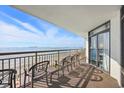 Ocean view from the condo balcony, complete with chairs and a table at 7200 N Ocean Blvd. # 1053, Myrtle Beach, SC 29572