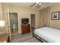 Comfortable bedroom with a bed, TV, and a connected bathroom providing a private retreat at 100 North Beach Blvd. # 1704, North Myrtle Beach, SC 29582
