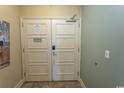 Condo entrance with a sturdy white door, showcasing safety features and clean design at 100 North Beach Blvd. # 1704, North Myrtle Beach, SC 29582