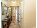 Inviting hallway featuring tile flooring, neutral walls, and decorative furnishings enhancing the home's interior at 100 North Beach Blvd. # 1704, North Myrtle Beach, SC 29582