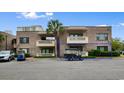 Two-story brick condo building featuring parking for golf carts at 10100 Lakeshore Dr. # C-1, Myrtle Beach, SC 29572