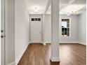 Inviting entryway with hardwood floors, white trim, and modern lighting fixtures at 1095 Nw Forest Bend Dr., Calabash, NC 28467