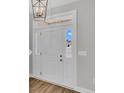 Elegant white front door with sidelights and transom window welcomes you into the home at 1105 Nw Forest Bend Dr., Calabash, NC 28467