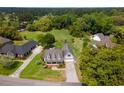 Sprawling property with lush green lawn, mature trees, and a charming home with inviting front porch at 120 Wraggs Ferry Rd., Georgetown, SC 29440