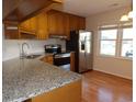 Kitchen featuring stainless steel appliances, granite countertops, and hardwood floors at 1208 Mackie Circle, Myrtle Beach, SC 29579