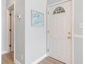 Charming entryway with wood-look flooring, decorative sign, and a white door with decorative window at 1210 A S Ocean Blvd., Surfside Beach, SC 29575