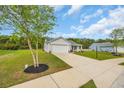 A lovely house on a well-maintained lawn with a long driveway and lush landscaping at 1340 Valor Rd., Conway, SC 29527