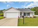 Beautiful one-story home featuring attached garage, green lawn, and an inviting front entrance at 1340 Valor Rd., Conway, SC 29527