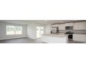 Bright kitchen with white cabinets, stainless steel appliances, and a center island with a sink at 144 Ashworth Dr., Tabor City, NC 28463