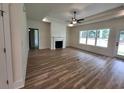 Bright living room features wood floors, a cozy fireplace, shiplap accent wall, and a ceiling fan at 1464 Hawthorn Dr., Pawleys Island, SC 29585