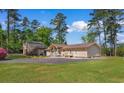 Spacious home exterior features a large driveway, well-maintained lawn, and a detached guest house at 164 Mohican Dr., Georgetown, SC 29440