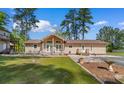 Beautiful home with a well-manicured lawn, patio, and charming landscaping at 164 Mohican Dr., Georgetown, SC 29440