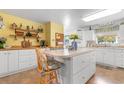 Bright kitchen features white cabinets, a center island with seating, and yellow accent wall at 164 Mohican Dr., Georgetown, SC 29440