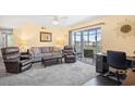 Comfortable living room with plush seating, ceiling fan and access to a private balcony at 1950 Bent Grass Dr. # K, Surfside Beach, SC 29575