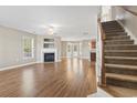 Spacious living room with fireplace, hardwood floors, and staircase at 211 Oak Landing Dr., Conway, SC 29527