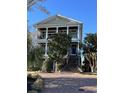 Charming three-story home with columned balconies and grand brick steps leading to a covered entry at 234 Ave. Of The Palms, Myrtle Beach, SC 29579
