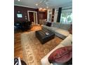 Spacious living room featuring a large sectional sofa, area rug, and dark accent wall at 234 Ave. Of The Palms, Myrtle Beach, SC 29579