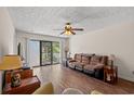 Inviting living room with hardwood floors, ceiling fan, and sliding glass doors leading to the outside at 3015 Old Bryan Dr. # 9-7, Myrtle Beach, SC 29577