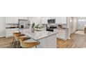 Modern kitchen with a large island, stainless steel appliances, granite countertops, and white cabinetry at 316 Clear Lake Dr., Conway, SC 29526