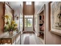 Bright foyer features a high ceiling, stylish console table, and direct view to front door at 3613 Pitchers Pl., Little River, SC 29566