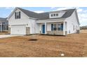 Charming two-story home featuring a 2-car garage, blue accents, and a welcoming front porch at 364 Hayloft Circle, Conway, SC 29526