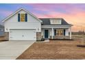 Charming two-story home featuring a 2-car garage, blue accents, and a welcoming front porch at 364 Hayloft Circle, Conway, SC 29526