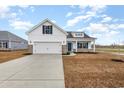 Charming two-story home featuring a 2-car garage, blue accents, and a welcoming front porch at 364 Hayloft Circle, Conway, SC 29526