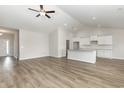 Bright living room with vaulted ceiling flows into a modern kitchen with white cabinets and granite countertops at 364 Hayloft Circle, Conway, SC 29526
