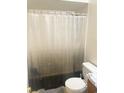 This functional bathroom showcases a toilet and shower with a curtain, providing the essential amenities for daily use at 401 Cambridge Circle # A5, Murrells Inlet, SC 29576