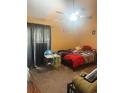 This spacious bedroom has a bed, table, and ceiling fan, creating an adaptable and airy environment for comfort and leisure at 401 Cambridge Circle # A5, Murrells Inlet, SC 29576