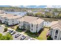 Aerial view of a condo building complex by the water with lush landscaping and ample parking at 4409 Eastport Blvd. # E2, Little River, SC 29566