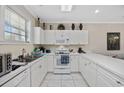 Bright kitchen featuring white cabinets, appliances, and ample counter space at 4679 Wild Iris Dr. # 103, Myrtle Beach, SC 29577