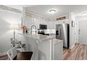 Bright kitchen with granite countertops, stainless steel appliances, and white cabinets at 720 North Waccamaw Dr. # 312, Murrells Inlet, SC 29576