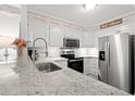 Well-lit kitchen with stainless steel appliances, white cabinets and granite countertops at 720 North Waccamaw Dr. # 312, Murrells Inlet, SC 29576