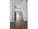 View of hallway with wood floors leading to the living space with an ocean view at 811 N Ocean Blvd. # 401, Surfside Beach, SC 29575