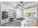 Bright modern kitchen featuring stainless steel appliances, a large island and custom backsplash at 817 Evans Rd., Marion, SC 29571