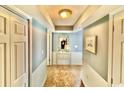 Inviting hallway with neutral tones, tiled floor, decorative mirror, and framed artwork at 8560 Queensway Blvd. # 304, Myrtle Beach, SC 29572