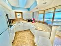 Bright kitchen features tile flooring, granite countertops, white cabinets, and ocean views at 8560 Queensway Blvd. # 304, Myrtle Beach, SC 29572